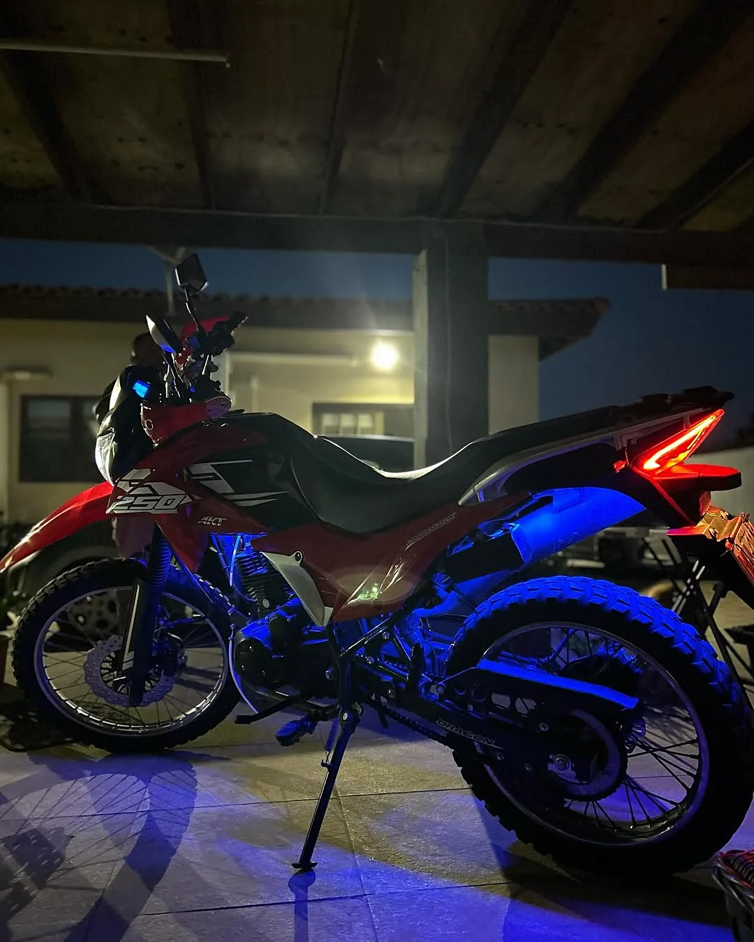 A bike lit from underneath in blue at night