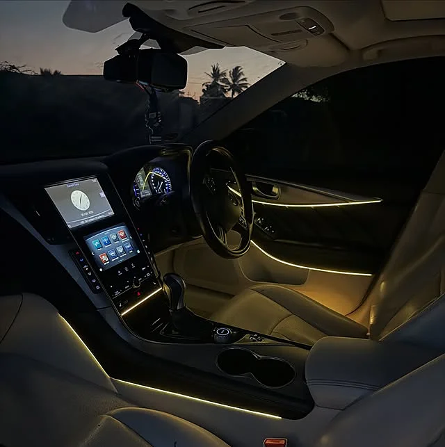 A single ambient light line running across an Infiniti Q50 dash and door